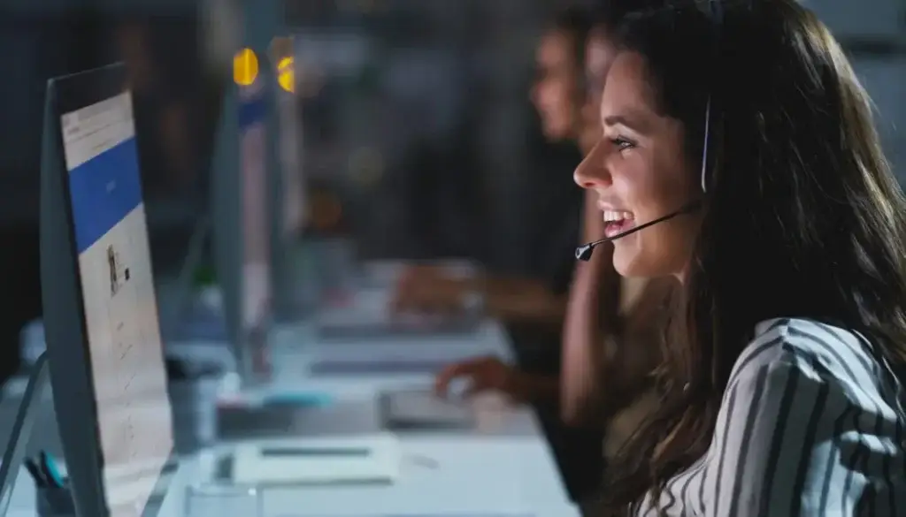 a-woman-wearing-a-headset-and-using-a-computer